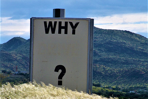 "Why" text on sign